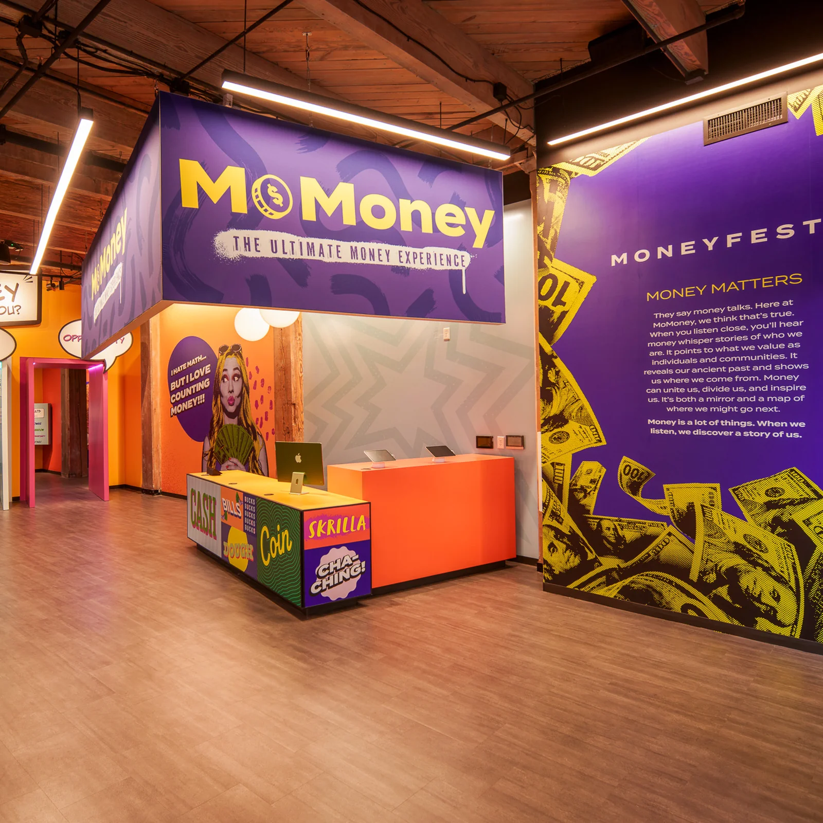 MoFun's lobby: purple signage above an orange reception desk, with speech-bubble doorways and the Moneyfesto wall.